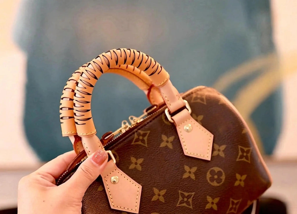 Tan leather handle wrap with cutout design on monogram bag, stylish replacement strap accessory