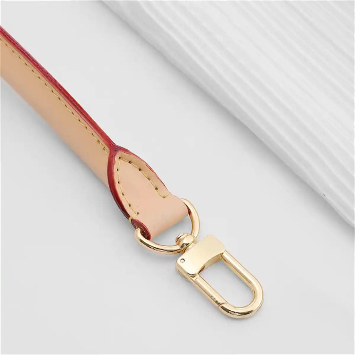 Tan leather bag strap with red edge and gold hardware, replacement accessory for handbags