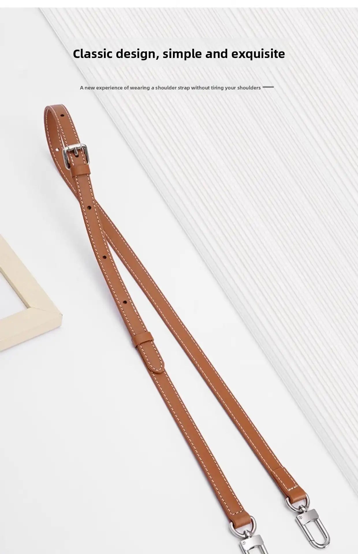 Tan leather shoulder strap with white stitching, adjustable buckle, and metal clasps for bags