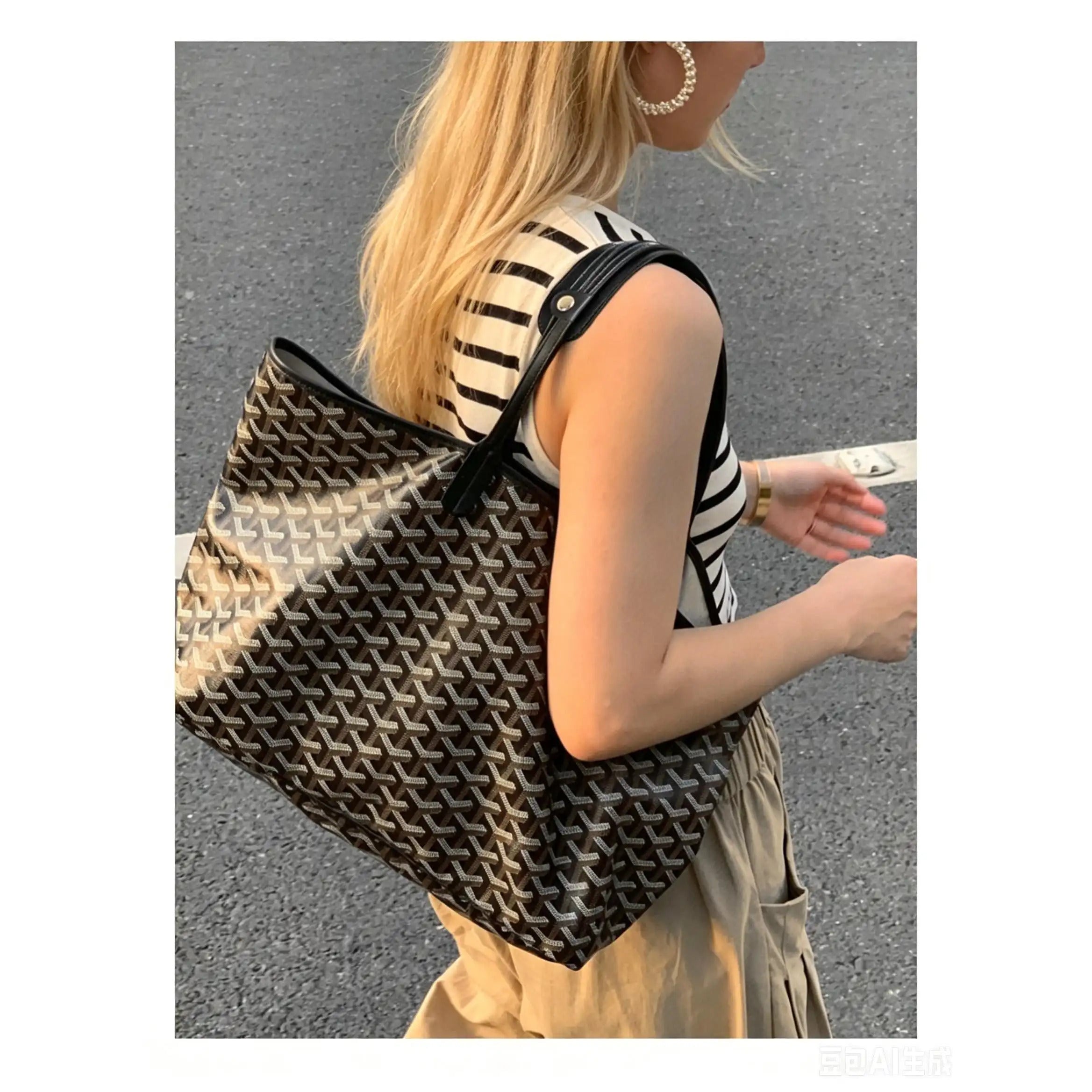 Stylish tote bag with geometric pattern and black leather strap, worn by woman in striped top.