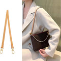 Tan leather bag strap with gold hardware, shown on a brown shoulder bag for stylish accessory upgrade.
